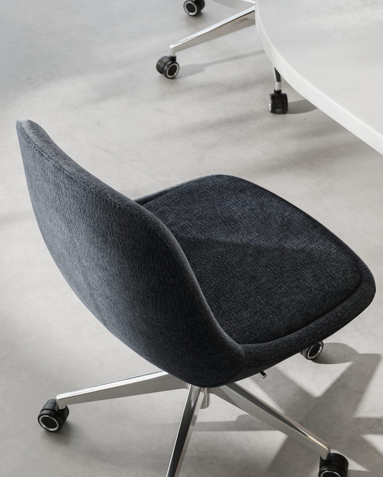Mary swivel chair from above beside a meeting table